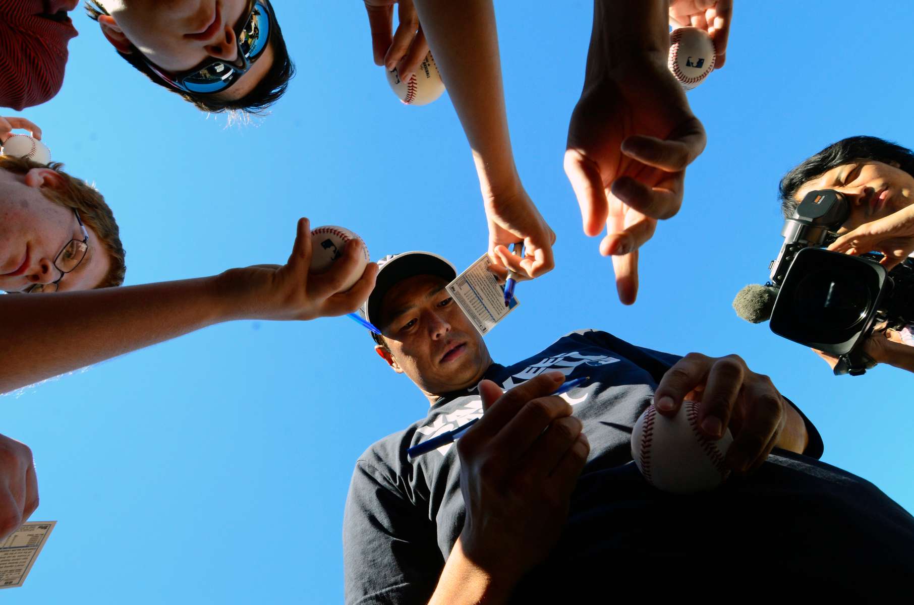 New York Yankees starting pitcher Hiroki Kuroda signs autographs after the Yankees workout on Sunday, February 16, 2014 at George M. Steinbrenner Field in Tampa, Fla.