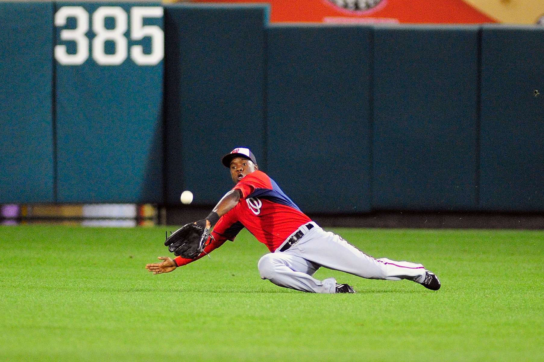 Washington Nationals center fielder Eury Perez (3) dives to try and make a catch in the sixth inning as the Atlanta Braves beat the Washington Nationals 3-2 on Wednesday March 6, 2014 at Champion Stadium in Lake Buena Vista, Fla.