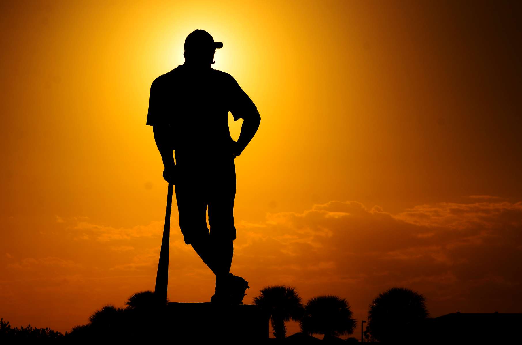 The sun sets behind a statue outside Space Coast Stadium on Sunday, March 2, 2014 in Melbourne, Fla after the Washington Nationals beat the Miami Marlins 10-3 in Spring Training.