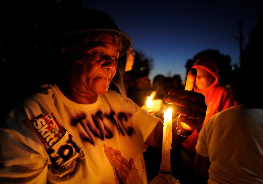 Gwen Lawrence, of Sanford, Florida, mourns during a candlelight vigil for Trayvon Martin in Sanford, Florida, March 25, 2012.  Martin, 17, was shot dead on February 26 after George Zimmerman, 28, a neighborhood watch captain, believed the young man walking through the gated community in a hoodie looked suspicious. Zimmerman followed him and an altercation ensued. Zimmerman has said he was acting in self-defense.