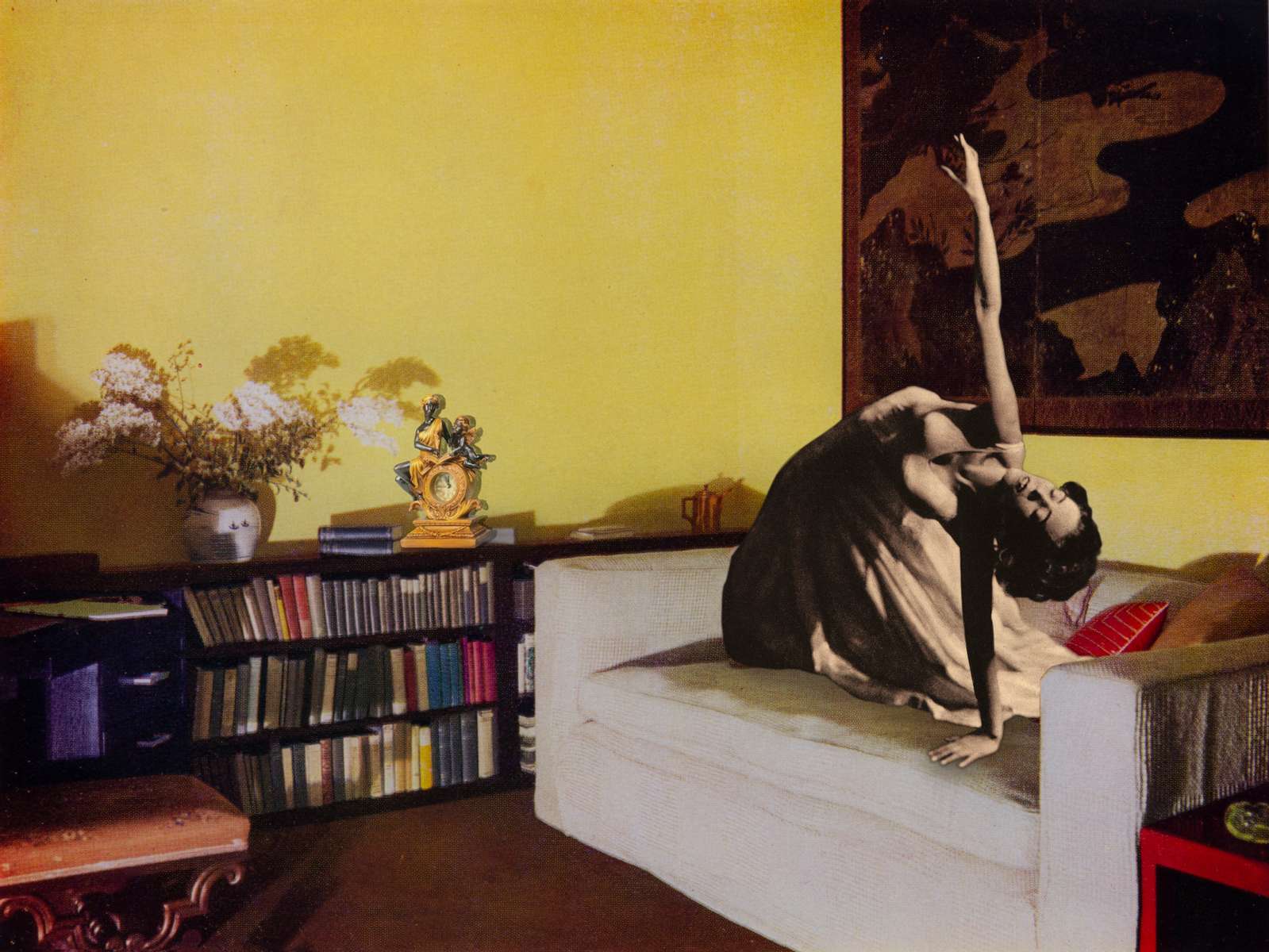 Mary Wigman poses on a large settee in a room with Chinese yellow varnished walls. Behind Mary is an 18th century Japanese screen in tones of gold and black. Design by Derek Patmore. (2018)