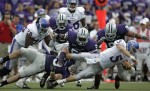 Kansas quarterback Todd Reesing (5) tries to escape from John Houlik (bottom left) and the rest of The Kansas State defense.