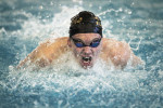 Chris Hearl of Blue Valley High School competes in the 100 yard butterfly.