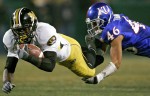 Missouri wide receiver Jeremy Maclin (left) is slowed down by Justin Thornton of Kansas.