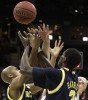 Terrence Oglesby (right) of Clemson gets mugged by Michigan teammates C.J. Lee (left) and Manny Harris (right) during the mens NCAA Tournament.