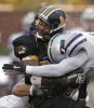 Missouri running back Tony Temple takes a shot from Byron Garvin of Kansas State during a rain soaked gameday.