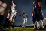 Head referee, Frank Phillips shows the winning toss of the coin to Limon High School football captains, left, and members of Akron High School on Friday 09/25/09 in Akron, Colo. Photo by Matt McClain