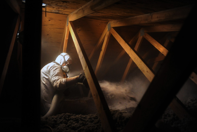 Jose Guillen of Energy Saving Partners weatherizes the attic of a home in Greeley, Colo. Wednesday 07/22/09.  Photo by Matt McClain