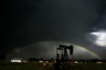 An oil derrick sits in a field as a thunderstorm blows through the town of Dacono, Cclo. Tuesday 8/14/07.  For many the amount of natural gas and oil production in Weld County represents the pot of gold at the end of the rainbow.  Photo by Matt McClain