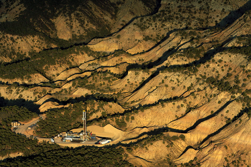 A drilling pad is nestled amid the ridges of the Roan Plateau in northwest Colorado.  There are currently over 30,000 active wells in Colorado as thousands more are on the drawing board.  Photo by Matt McClain