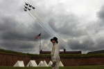 Reenactor, Gary Schwartz of Silver Spring, MD stands near an encampment as the Blue Angels fly overhead during the Star-Spangled Spectacular Air Show which was part of the festivities celebrating the 200th anniversary of the penning of {quote}The Star-Spangled Banner{quote} and the Battle of Baltimore at Fort McHenry National Monument and Historic Shrine on Saturday September 13, 2014 in Baltimore, MD.  (Photo by Matt McClain/ The Washington Post)