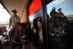 Miss Rodeo Colorado, Audra Dobbs, left, sits on her horse, Sequoia as she suprises Lizeth Saemz at a McDonalds drive thru window  as participants of the Rocky Mountain Horse Expo got in the drive thru line to get shakes after putting on a display for students at Garden Place Academy in Denver, Colo.  Photo by Matt McClain