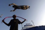 Practicing before the first performance of the evening for Circus H. Vazquez, Nick Hegwood, 16, jumps a rope as Montie Bledsoe, 20, uses a trampoline to sky over him at Seaside Park in Ventura, Calif.  Photo by Matt McClain