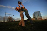 Eli Dunn, 7, left, competes for a fly ball with Dylan Carey, 8, right, as Dylan's father, Marc Carey throws pop ups to them in an open space near the Platte River in Denver, Colo. on Saturday 11/07/09.  Photo by Matt McClain