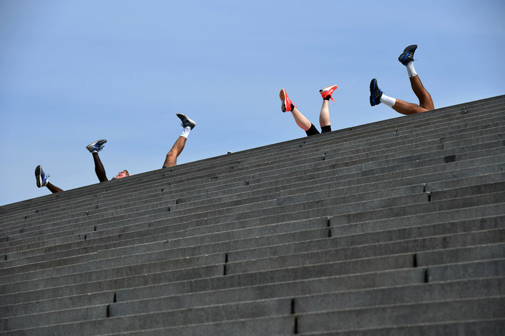 Taking advantage of weather, people do leg lifting exercises at the top of steps on Tuesday April 19, 2016 in Washington, DC. (Photo by Matt McClain/ The Washington Post)