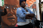 Qiara Butler, who is the cousin of Tyrone West, joins with fellow family members and others for a rally for West in front of a mural portraying Freddie Gray on Wednesday April 20, 2016 in Baltimore, MD. The city saw unrest following the death of Freddie Gray last year. (Photo by Matt McClain/ The Washington Post)