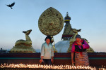 Women light candles as they celebrate Buddha Purnima which commemorates the birthday of Buddha near the Boudhanath stupa on Monday May 04, 2015 in Kathmandu, Nepal. Scores of people gathered for the festival near the historic stupa. (Photo by Matt McClain/ The Washington Post)