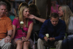 Amanda Lindren, second from left, girlfriend of shooting victim, Alexander Teves is comforted while she grieves with others closely associated with the victims of the Century Aurora 16 movie theater shooting during a community vigil at the Aurora Municipal Center on Sunday July 22, 2012 in Aurora, CO.  Teves used his body to block Lindren from the gunfire and was killed.  The event was to honor the memories of those injured and killed in the deadly shooting Friday morning at the Century Aurora 16 that left twelve dead.  (Photo by Matt McClain for The Washington Post)