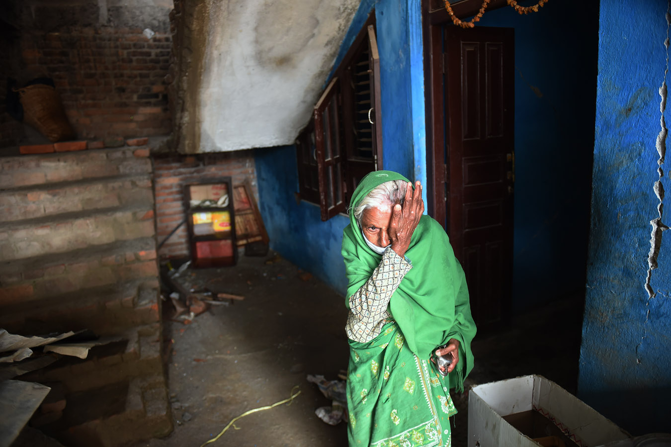 Sabitri Nepan wipes away a tear as she stands near her damaged home on Thursday April 30, 2015 in Kathmandu, Nepal. A deadly earthquake in Nepal has killed thousands. (Photo by Matt McClain/ The Washington Post)