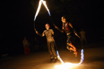 Karly Bellingham, left center, and Laura Durbin, right, practice with flaming jump ropes as they and other members of Revolutionary Motion work on a fire routine on Wednesday August 12, 2015 in Alexandria, VA. The group will be performing at the upcoming Burning Man festival in Nevada. (Photo by Matt McClain/The Washington Post)