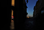 A pedestrian walks through a sliver of morning light on Saturday May 18, 2013 in Florence, Italy.  Florence is home to many Renaissance master works, including Michelangelo's David.  (Photo by Matt McClain/ The Washington Post)