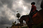 Manuel Macuils sits horseback as he advertises an equestrian event to be held later that night on Sunday June 09, 2013 in Cordoba, Spain.  The city is located in southern Spain.  (Photo by Matt McClain/ The Washington Post)