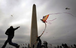 Josh Anson, left, of Silver Spring, MD helps his newphew, Isaiah Anson, right, get his dragon kite off the ground near the Washington Monument during the Cherry Blossom Kite Festival on Sunday 04/10/2011 in Washington, DC.  (Photo by Matt McClain/ For The Washington Post)