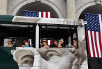 A sightseeing bus passes by American flags decorating Union Station on Sunday July 03, 2016 in Washington, DC. Monday is the Fourth of July. A strong chance of rain is being forecasted for the Washington, DC area on Monday. (Photo by Matt McClain/ The Washington Post)