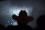 Wearing a cowboy hat, Howard Boyle gathers with others to watch fireworks from POV at W Washington, DC Hotel during the annual Fourth of July celebration on Monday July 04, 2016 in Washington, DC. (Photo by Matt McClain/ The Washington Post)