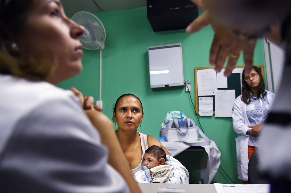 Rozilene Ferreira de Mesquita, center, holds her son, Arthur Ferreira da Conceicao as she listens to a doctor during a visit to Hospital das Clinicas da Universidade Federal de Pernambuco for Arthur on Monday March 14, 2016 in Recife, Brazil. Arthur was born with microcephaly, which the Zika virus is being linked to. (Photo by Matt McClain/ The Washington Post)