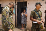 Tatiana Alves holds her one month old baby, Joao Pedro Alves as she speaks with members of the Brazilian military as they go door to door along with health care workers in a favela to talk to residents about the threat of Zika virus, dengue fever and chikungunya on Saturday March 12, 2016 in Recife, Brazil. The Zika virus has been rampant in this region. The virus is spread by the Aedes aegypti mosquito. (Photo by Matt McClain/ The Washington Post)