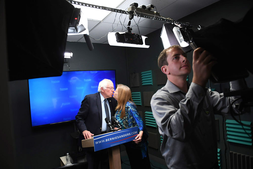 Presidential candidate, Bernie Sanders kisses his wife, Jane O'Meara Sanders as he prepares to speak for a video to supporters at Polaris Mediaworks on Thursday June 16, 2016 in Burlington, VT. (Pool Photo by Matt McClain/ The Washington Post)