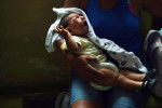 Micaela de Souza Celestino holds her daughter, Annika Vitoria Medeiros da Silva at Hospital das Clinicas da Universidade Federal de Pernambuco on Monday March 14, 2016 in Recife, Brazil. Annika was born with microcephaly, which the Zika virus is being linked to. The virus has been rampant in this region. It is spread by the Aedes aegypti mosquito. (Photo by Matt McClain/ The Washington Post)