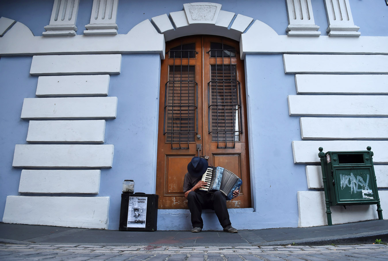A man plays an accordion for tips on Friday July 03, 2015 in Old San Juan, Puerto Rico. The historic area brings in countless tourists. (Photo by Matt McClain/ The Washington Post)