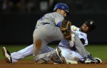  Los Angeles Dodgers' Jamey Carroll, left, steals second base after Eric Young Jr., right, loses the ball while applying the tag in the second inning of a baseball game at Coors Field in Denver, Colo. on Saturday, August 27, 2010.  (AP Photo/ Matt McClain)