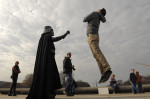 Roman Flaig, right, jumps in the air as he has his photograph taken with Rob Davis of Glen Burnie, MD, left, as he wears a Darth Vader costume near the United States Capitol on Sunday December 01, 2013 in Washington, DC.  Davis and others were promoting the Museum of Science Fiction.  Flaig jumped in order to make it look as if he was in the clutches of Darth Vader.  (Photo by Matt McClain/ The Washington Post)