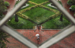 Viewed from a window of the Smithsonian Institution Building or the Smithsonian Castle an umbrella clad pedestrian makes their way by the Enid A. Haupt Garden on Wednesday September 28, 2016 in Washington, DC. (Photo by Matt McClain/ The Washington Post)
