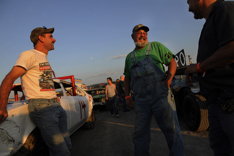 Herbie Polhemus, left, talks with David Cline, center, and Joey Montz Jr. right, prior to the beginning of the demolition derby at the Shenandoah County Fair on Tuesday August 28, 2012 in Woodstock, VA.  