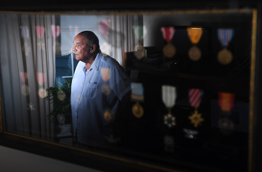 Carl C. Johnson, 90, is reflected in a display of his military medals as he poses for a portrait at his home on Monday August 22, 2016 in Ashburn, VA. Johnson was a member of the famed, Tuskegee Airmen. (Photo by Matt McClain/ The Washington Post)