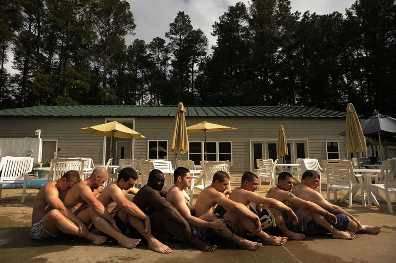 Participants of the Extreme SEAL Experience sit together to stay warm during pool exercises on Wednesday May 18, 2011 in Chesapeake, VA.  Men from around the country paid money to learn techniques used in Navy SEAL training.  (Photo by Matt McClain/For The Washington Post)