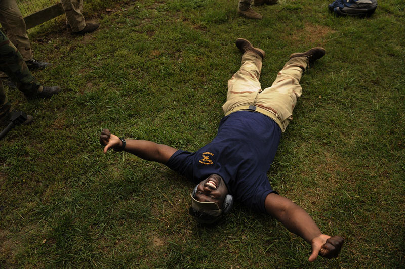 Showing his enjoyment, Darion Brown, 36, of California lays on the ground after firing a 50 caliber sniper rifle while taking part in the Extreme SEAL Experience on Wednesday May 18, 2011 in Chesapeake, VA.  Men from around the country paid money to learn techniques used in Navy SEAL training.   (Photo by Matt McClain/For The Washington Post)