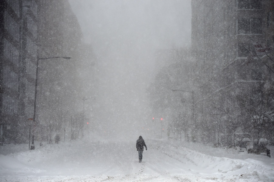 In nearlywhite out conditions, a person makes their way up I Street NW street on Saturday January 23, 2016 in Washington, DC. A large snow event was being predicted for Washington, DC area. (Photo by Matt McClain/ The Washington Post)