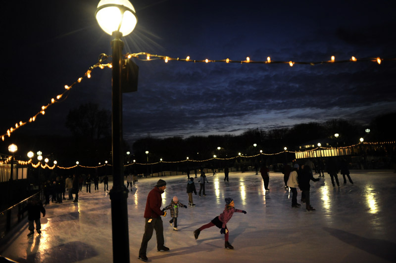 As  the last light of the day fades away, families skate at the National Gallery Sculpture Garden and Ice Rink on December 21 in Washington, DC. (Photo by Matt McClain For The Washington Post)