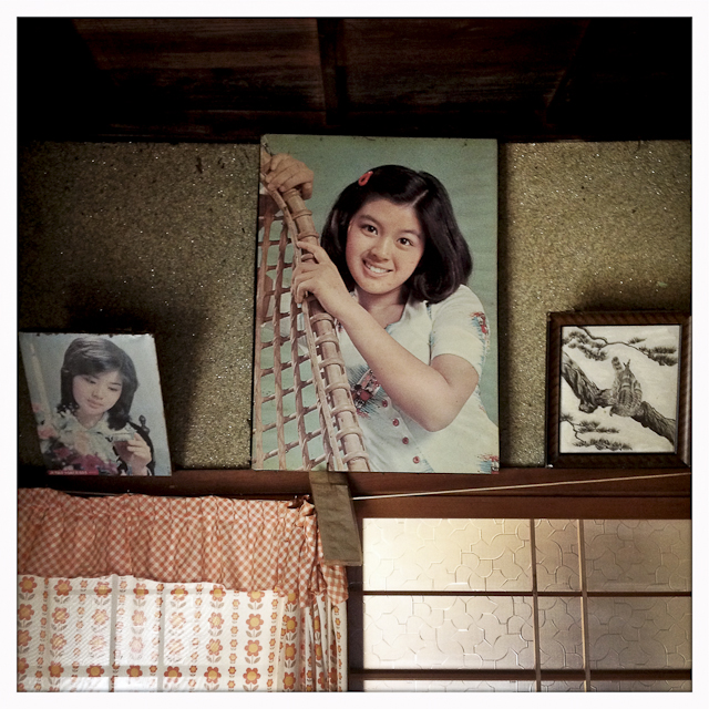 An old picture of a 70's teen idol remains hanging on the wall of an abandoned house owned by Eiko Nakano, 86, who lives in a nearby group home called Kouyou-no-Sato, which means fall foliage.  