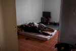 Asylum-seekers sleep in their one room apartment as there is very little socializing or entertainment going on. They mostly stay inside the building in fear of being arrested on the streets by immigration police for not having legal status in Thailand. Apr. 2015