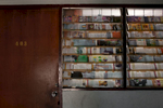A window of a one room apartment covered by magazine pages inside one of the main buildings that house hundreds of asylum-seekers, mostly from Pakistan, Somalia and Sri Lanka. Mar. 2015