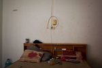 The bed of an asylum-seeker from Pakistan, who has been living inside this room since Dec 2013. Mar. 2015
