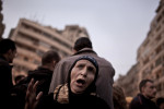 An Egyptian woman chants anti-goverment slogans as protesters gather around awaiting an evening of demonstrations in Tahrir Square. Cairo, Tuesday, Feb. 8, 2011