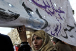 An Egyptian female protester takes part in demonstrations at Tahrir Square in Cairo. Tuesday, February 8, 2011