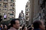 An Egyptian soldier atop an army tank contiues to keep watch of opposition supporters during a rally outside of Tahrir Square. Cairo. February 9, 2011